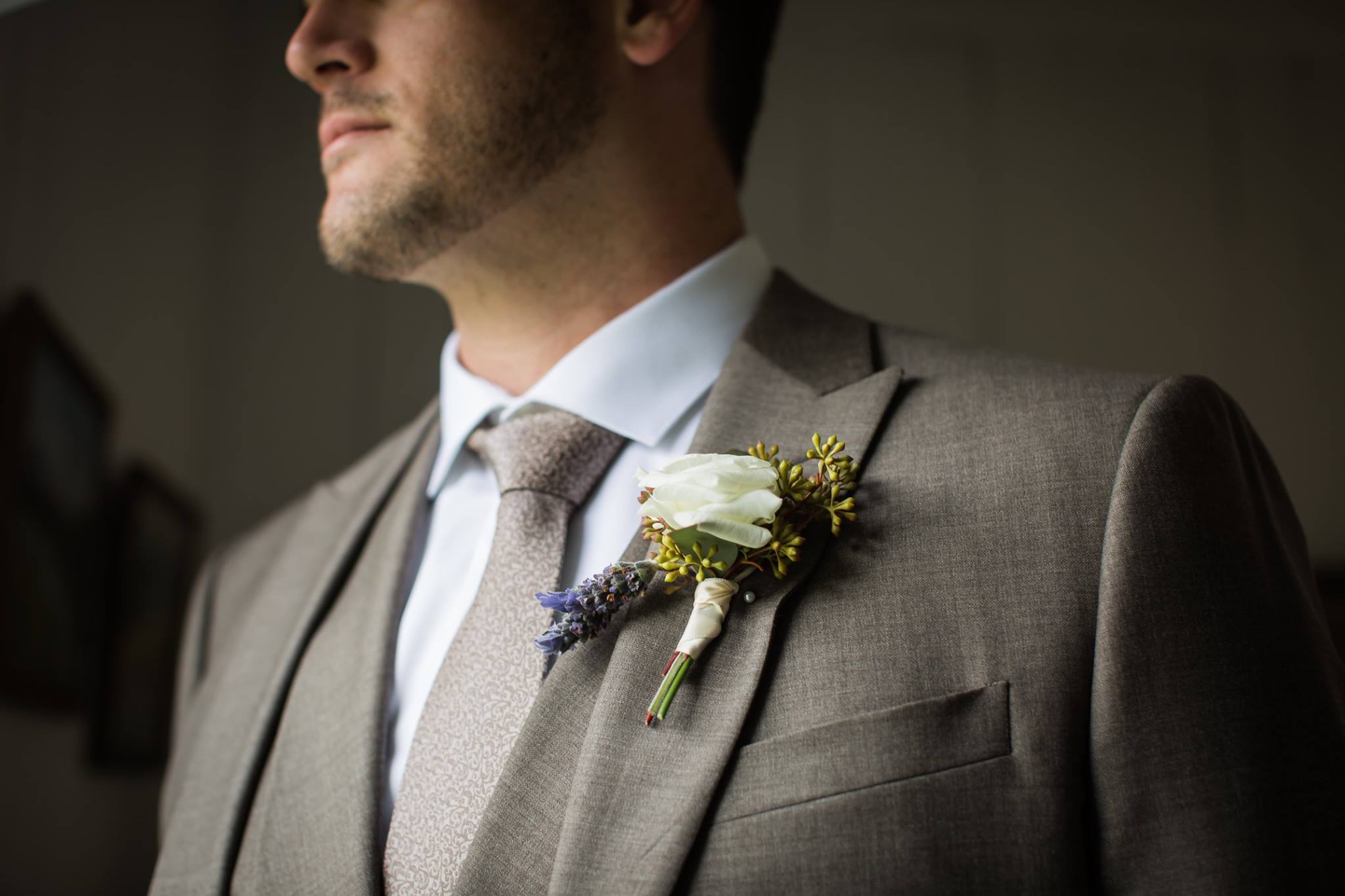  detail shot of groom’s suit and boutonniere 