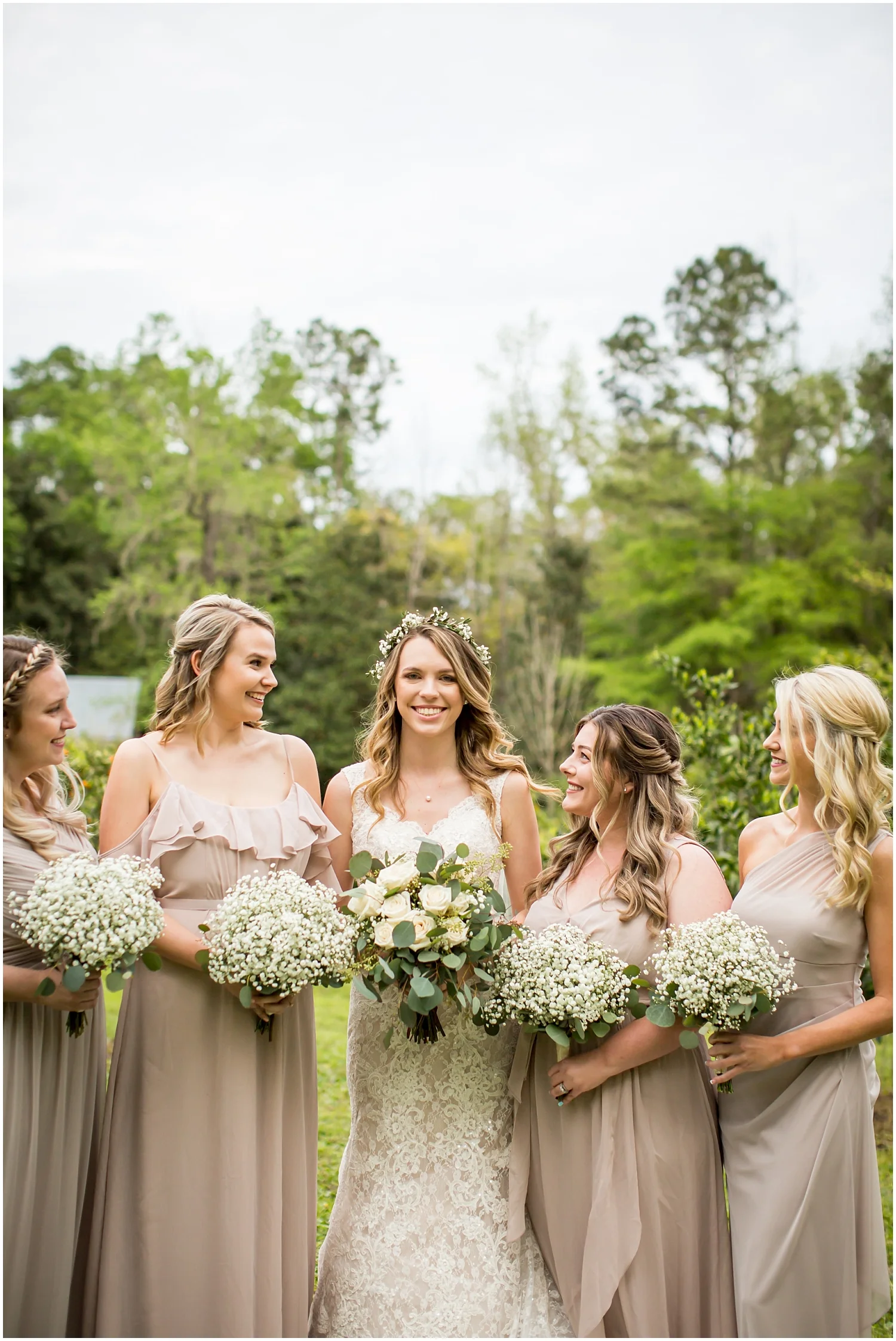  bride and bridesmaids holding their wedding bouquets 