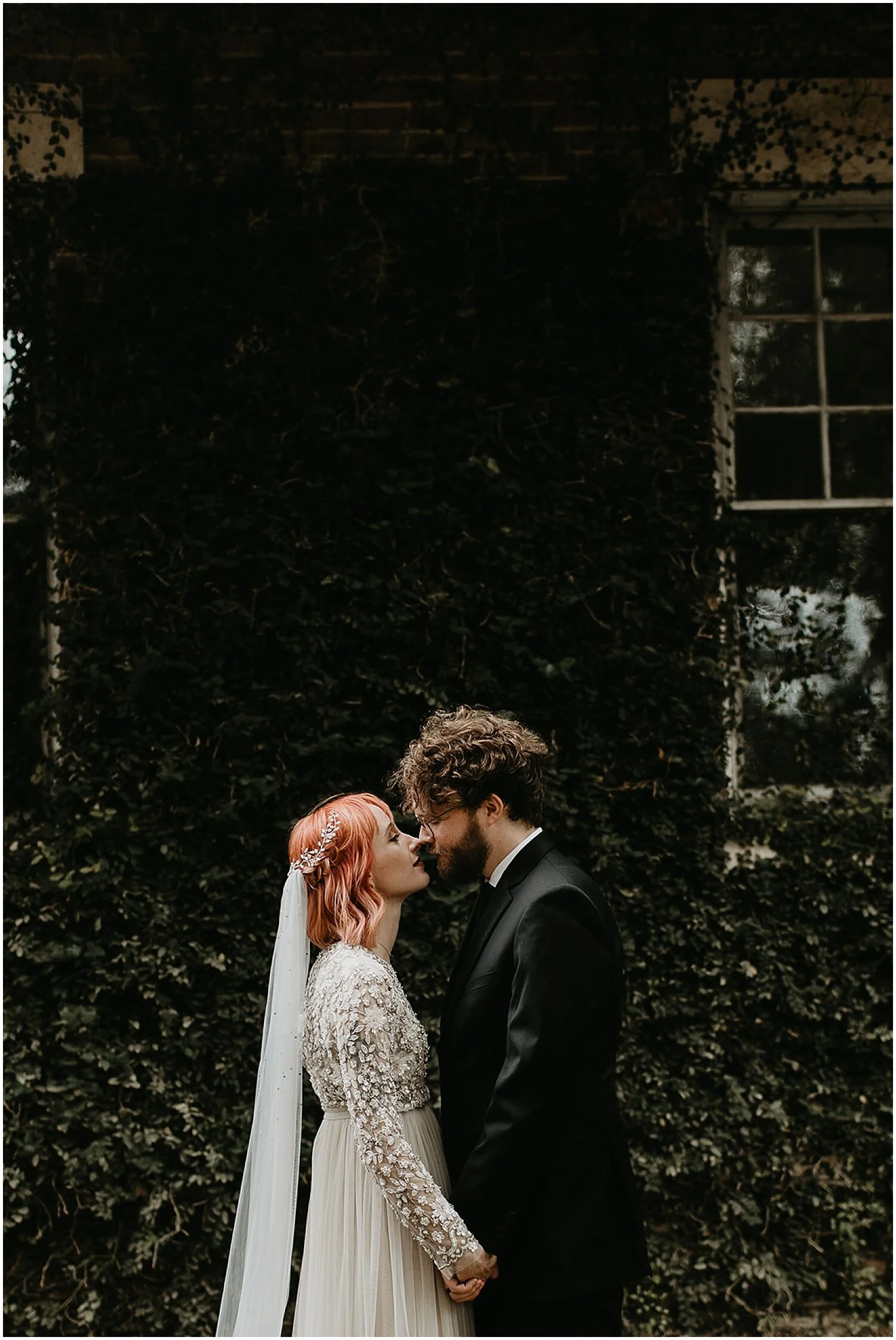  bride and groom portrait with greenery background 