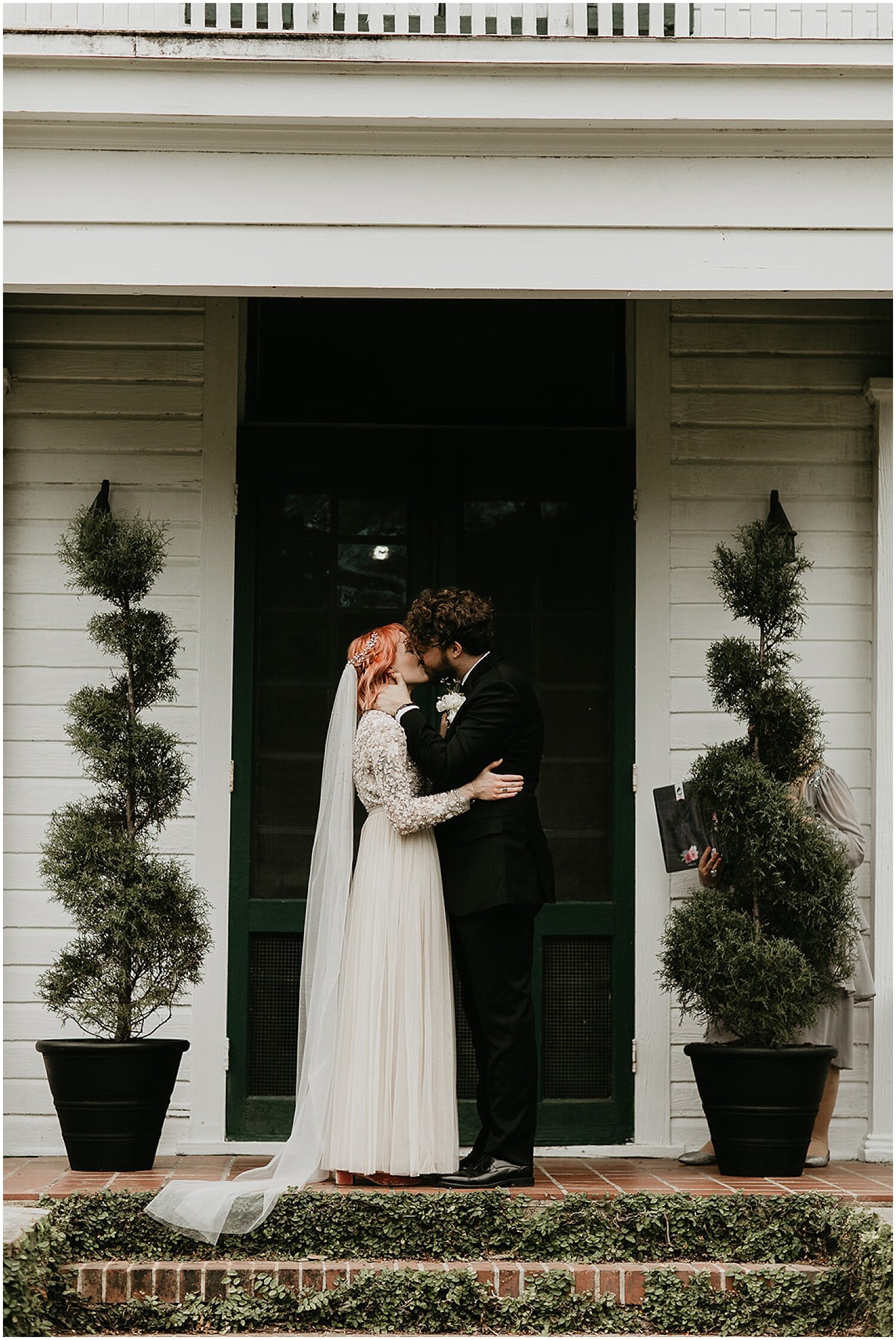  bride and groom kiss at their wedding ceremony 