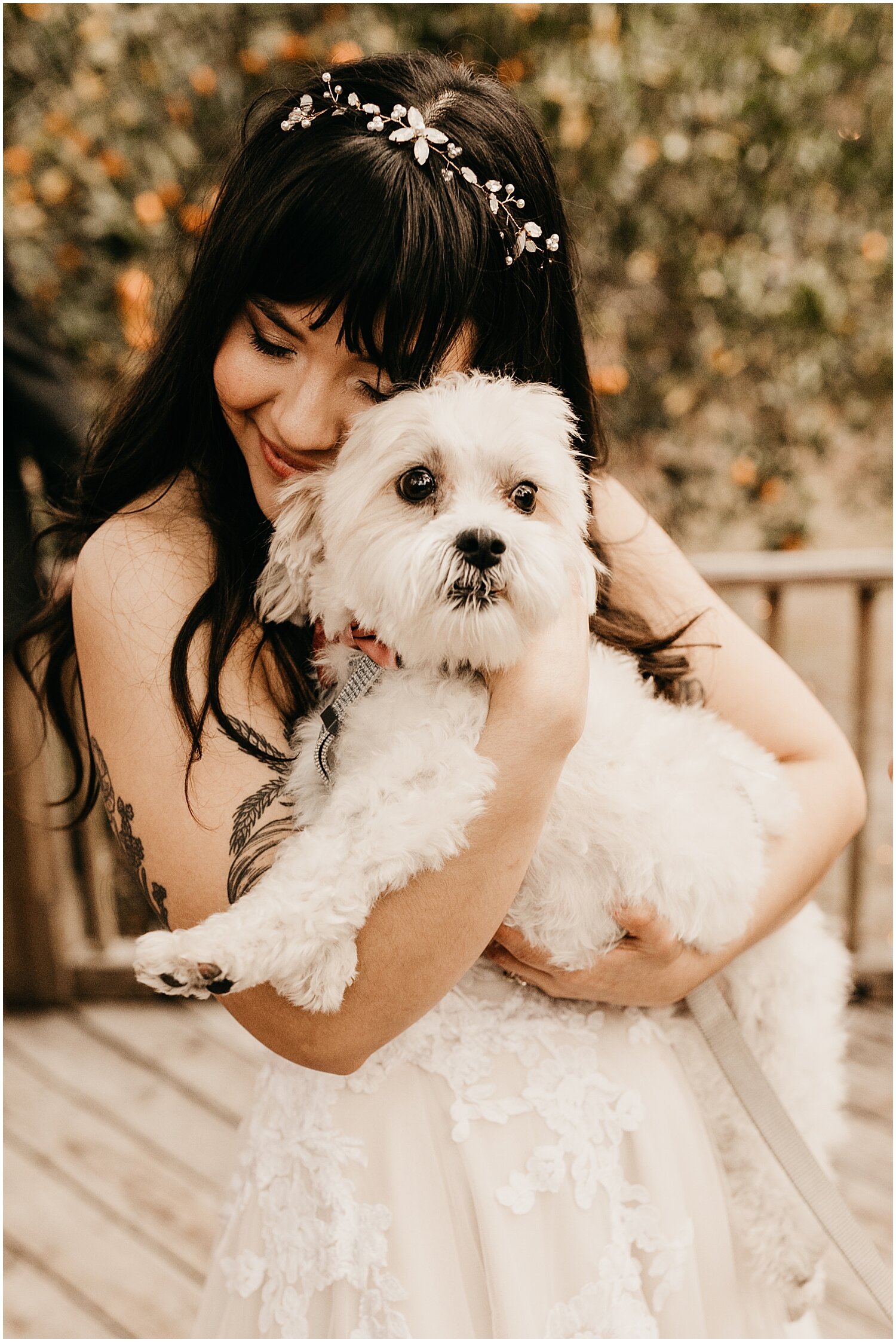  bride holding her doggy during the wedding 