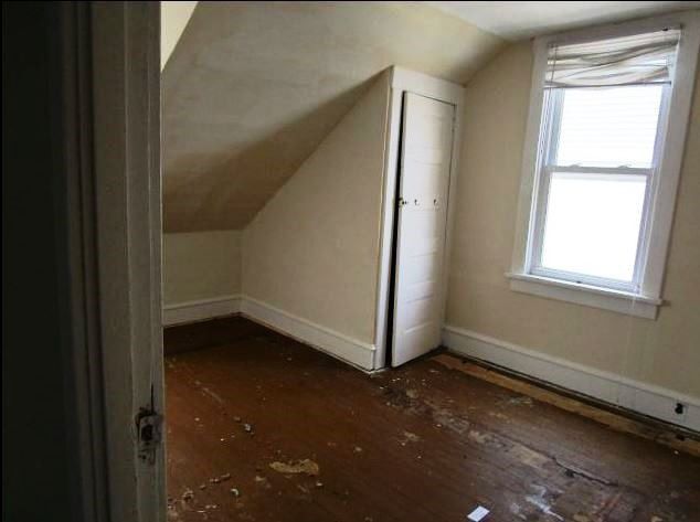 2nd floor bungalow bedroom with dormers and slanted roof.
