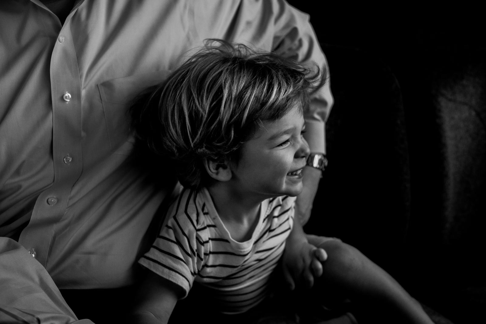 Dad hugging son who is giggling