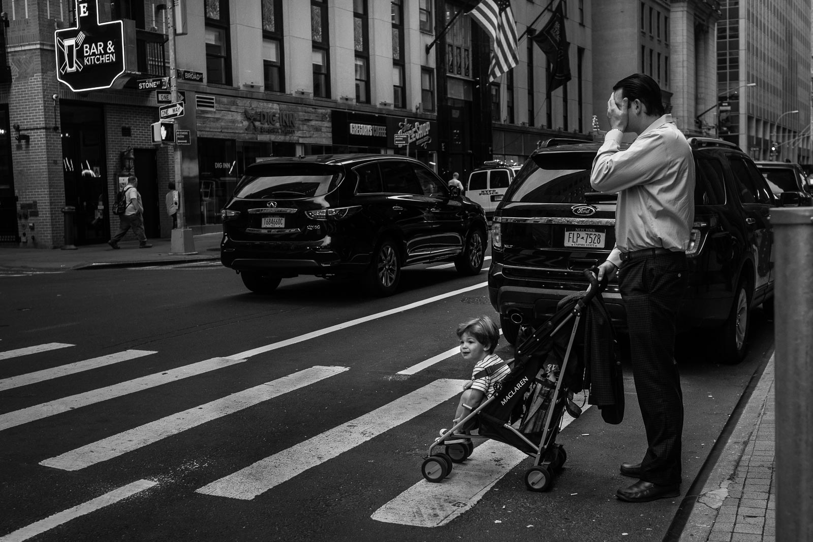 Father and son crossing NYC street in stroller