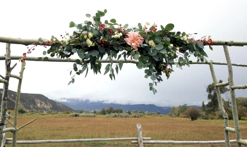 Arbor arrangement dahlia, rose hips, eucalyptus, spray roses.