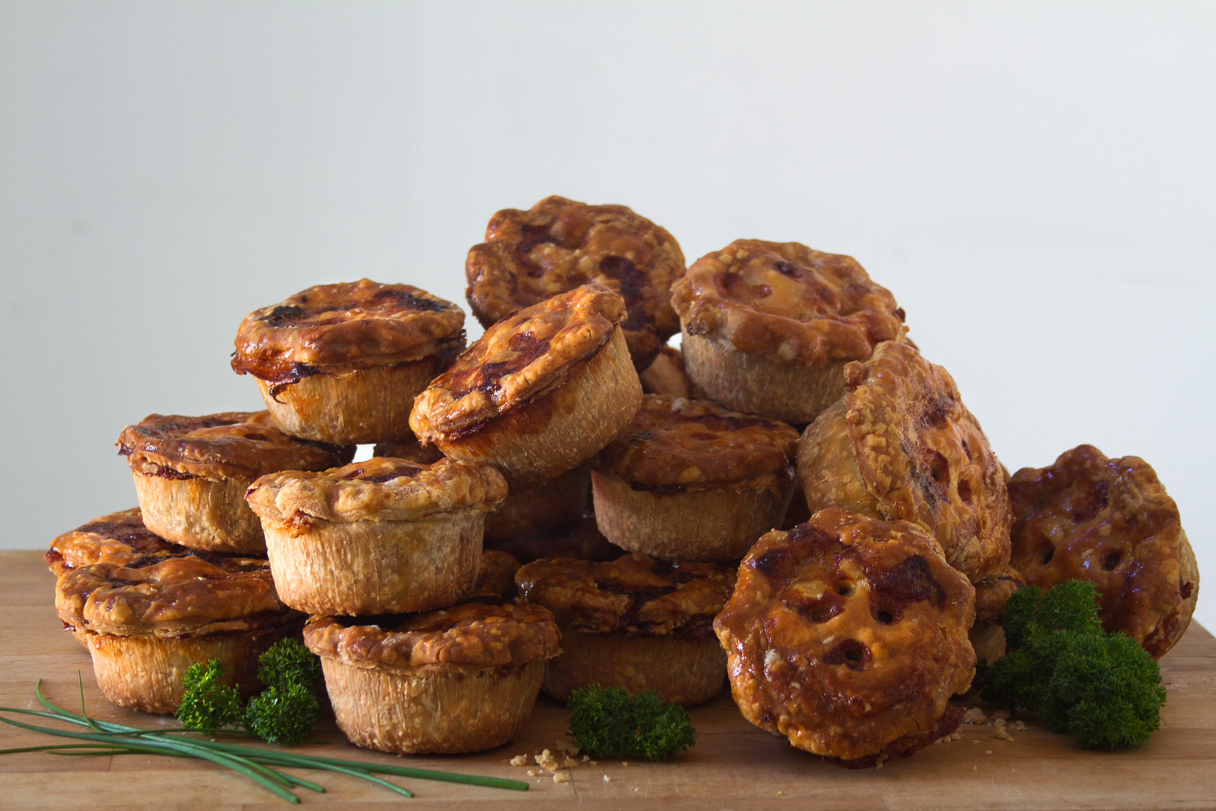 A stack of hand made, luxury pork pies