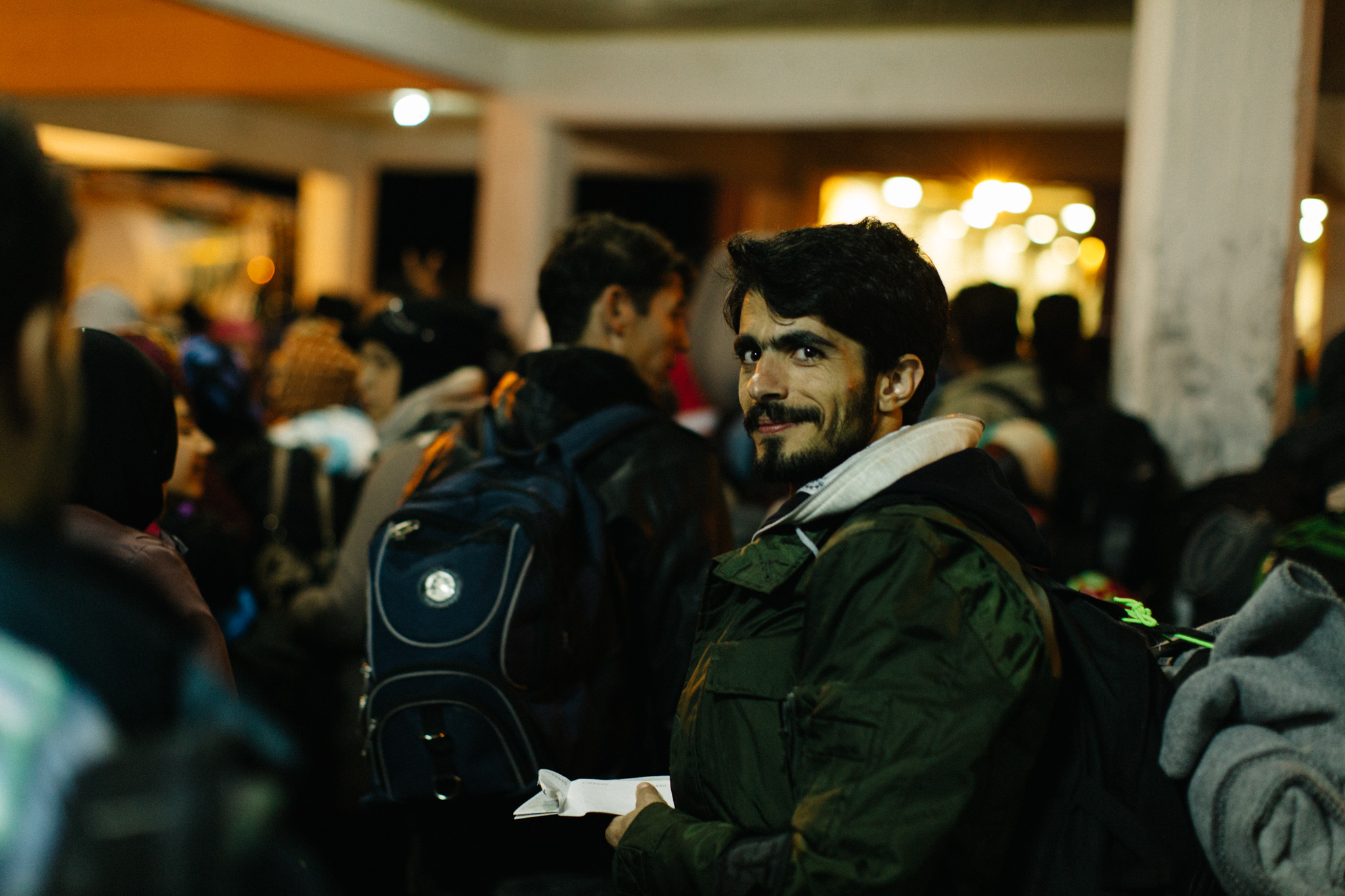 Iman Miri, papers in hand, is all smiles as he boards the ferry to Athens–one important step closer to Germany.