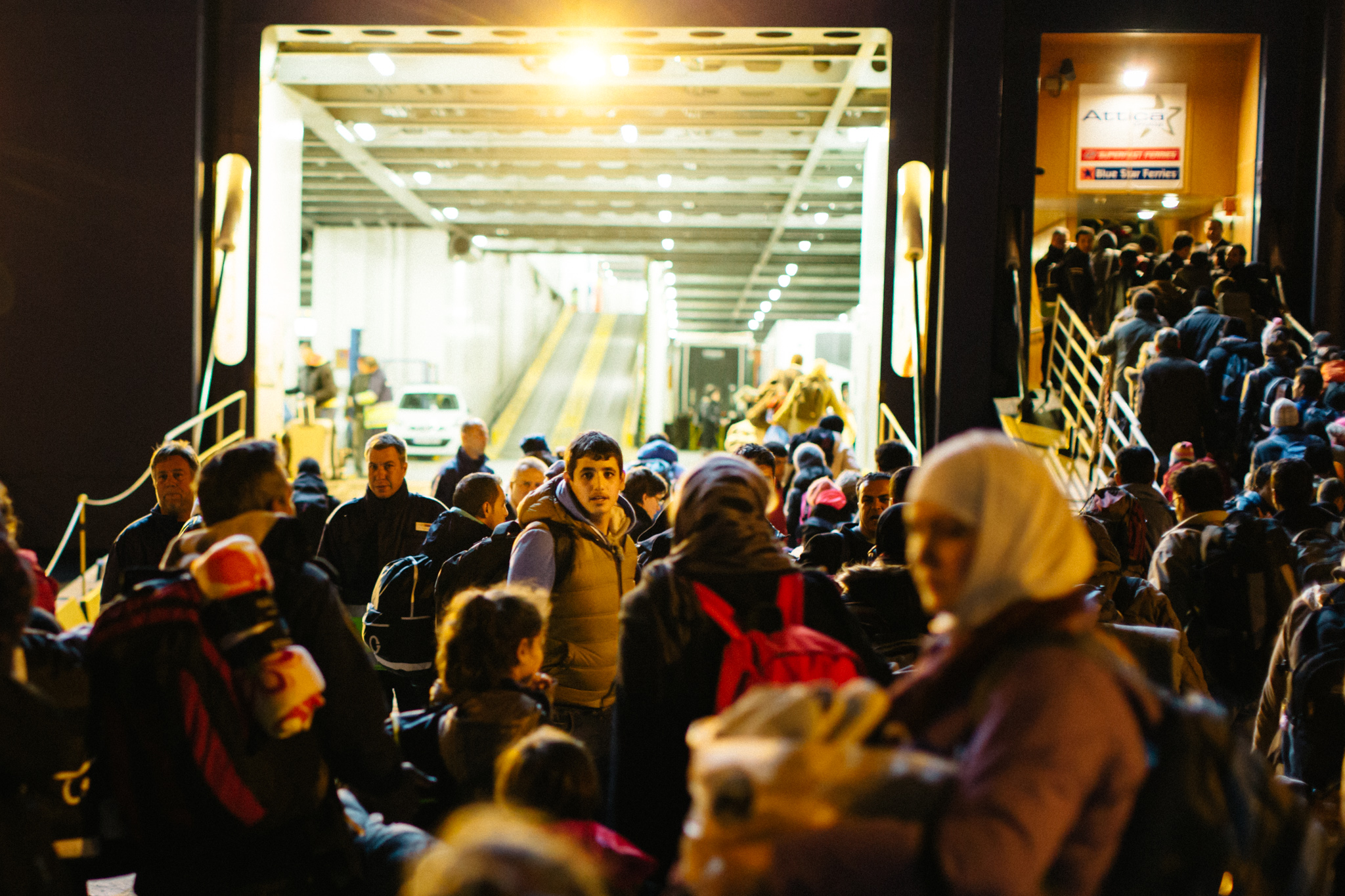 In a moment of pause, a young man looks back across a sea of people boarding an Athens bound ferry. Like so many thousands before him, he leaves Leros behind and continues his determined and uncertain march towards Northern Europe in the shadow of tightening EU legislation. 