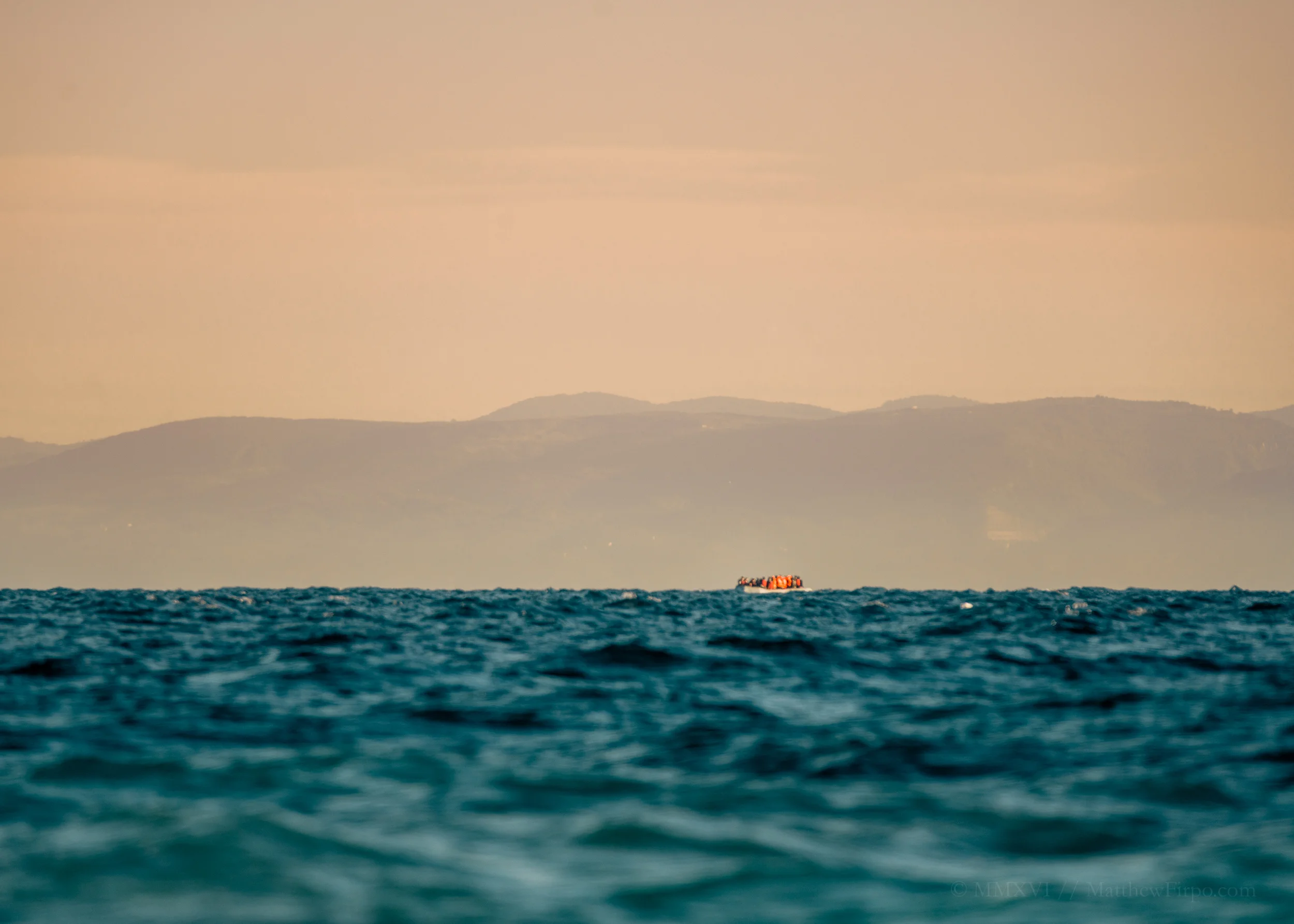 Landings Mytilini, Lesvos, Greece | 39.2645° N, 26.2777° E The first boats begin landing before dawn. Sometime around five in the morning, long before the light, families touchdown on Greek shores after a journey through the long dark. Here, at just after dawn, a group makes the voyage. Distances are deceiving at sea, and even with the Turkish Coast so visible in the distance, it's no simple crossing. Over three hours in nearly-freezing weather, on a zodiac made for short-range travel, refugees arrive traumatized and shaken. Seen here with effectively a 600mm lens, a boat well over 2-miles away prepares for the final stretch.