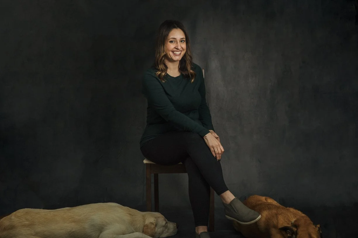 Image of photographer with two dogs at feet