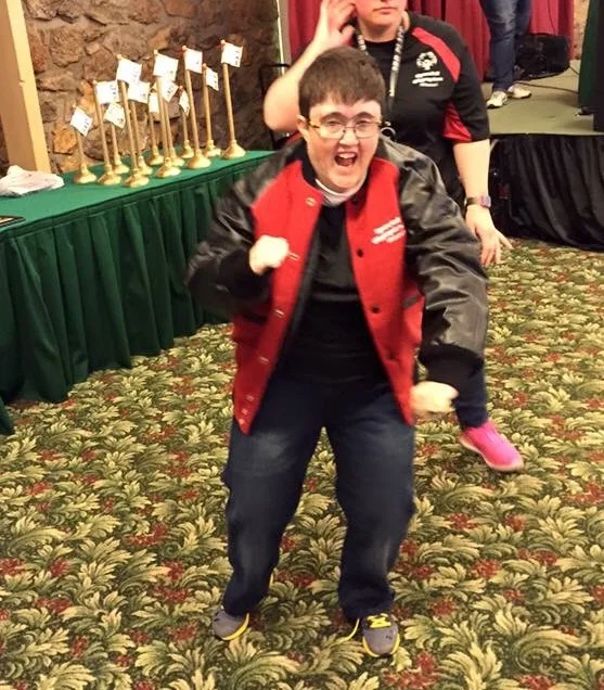 SOMO athlete Beth Brokamp of Columbia celebrates after receiving her letter jacket for raising $5,000 to go toward the Training for Life Campus.