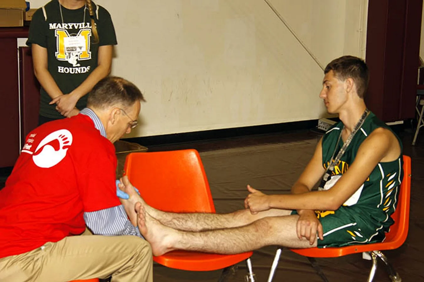 An athlete receives podiatry care during the Fit Feet discipline of Healthy Athletes at State Summer Games at Missouri State University