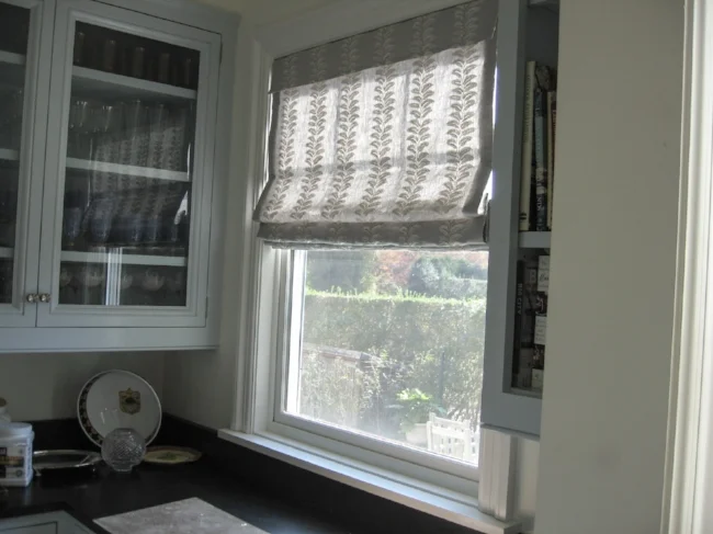 Sage linen with white embroidery. Tailored roman shade with front and back small valence to cover mechanism.