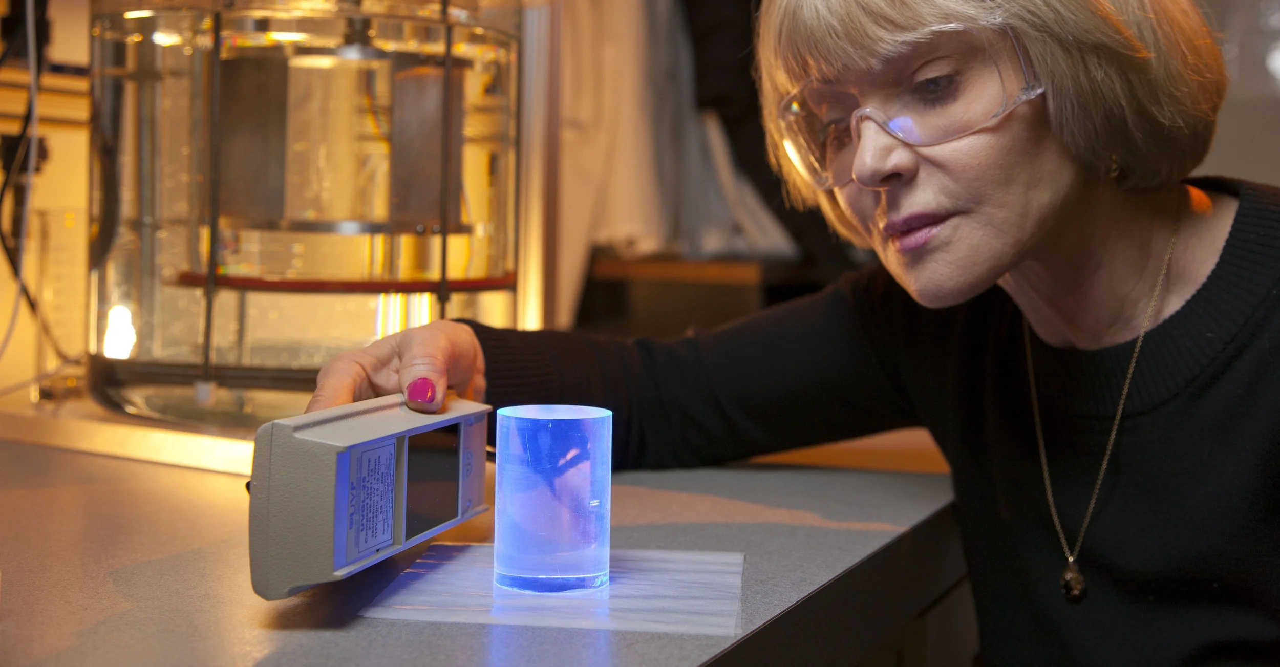 Photo 9_Researcher examining an NNSA-developed advanced plactic radiation detection material.jpg