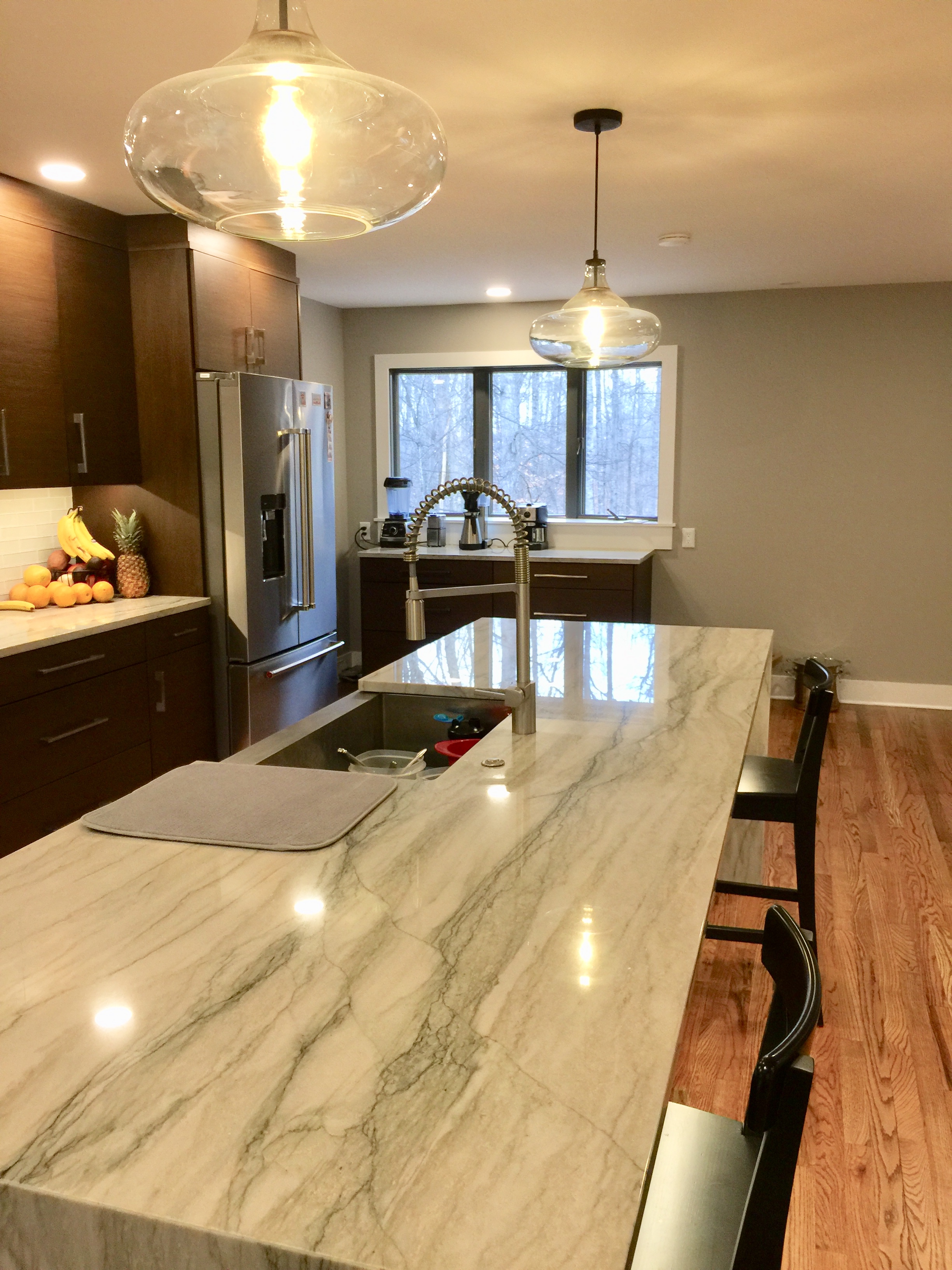 The Sea Pearl Quartzite they chose is outstanding. Note the coffee bar in the back.