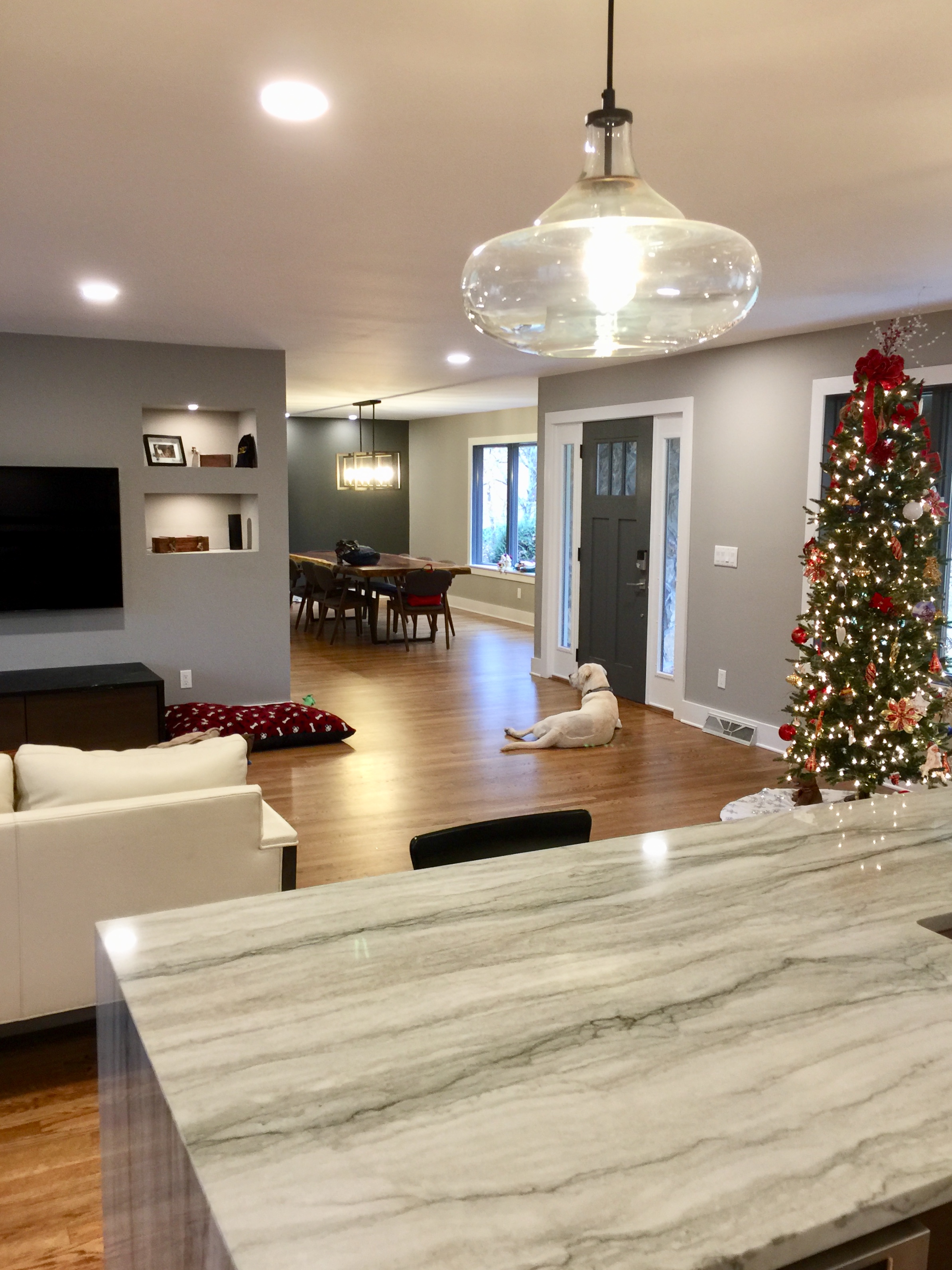 The adjacent dining room also got special treatment. They chose a stunning chandelier and the back wall is lit and ready for future art and furniture purchases.