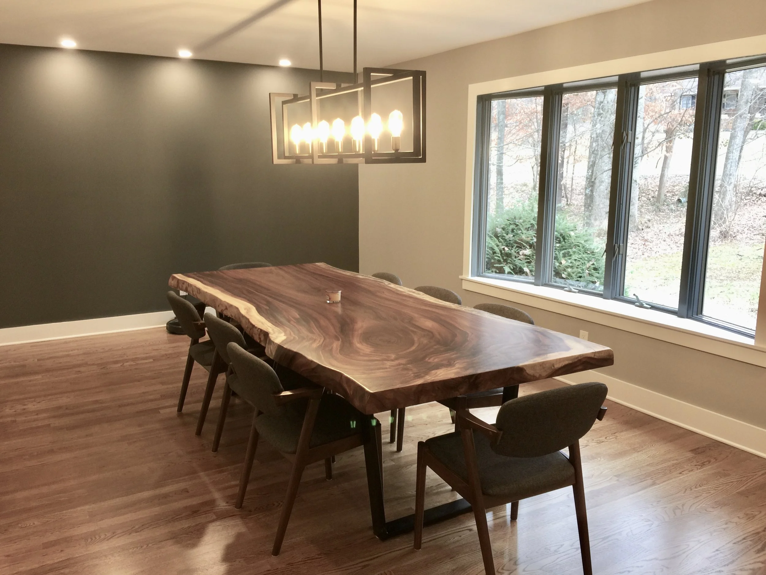 The bespoke live-edge dining room table was built by a woodworker in Blowing Rock, NC. 