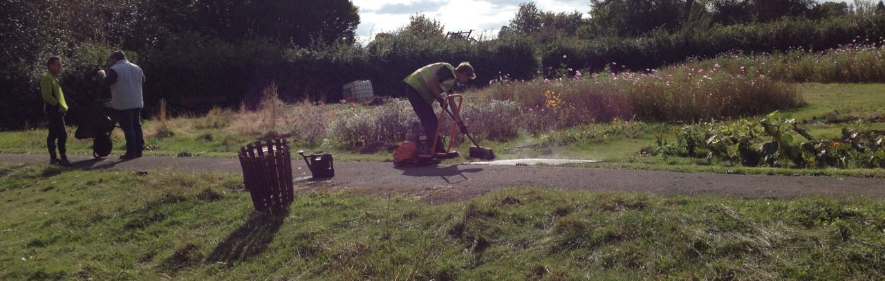 Laying the tarmac, with the recycled (soon-to-be-connected) water tank in the background...