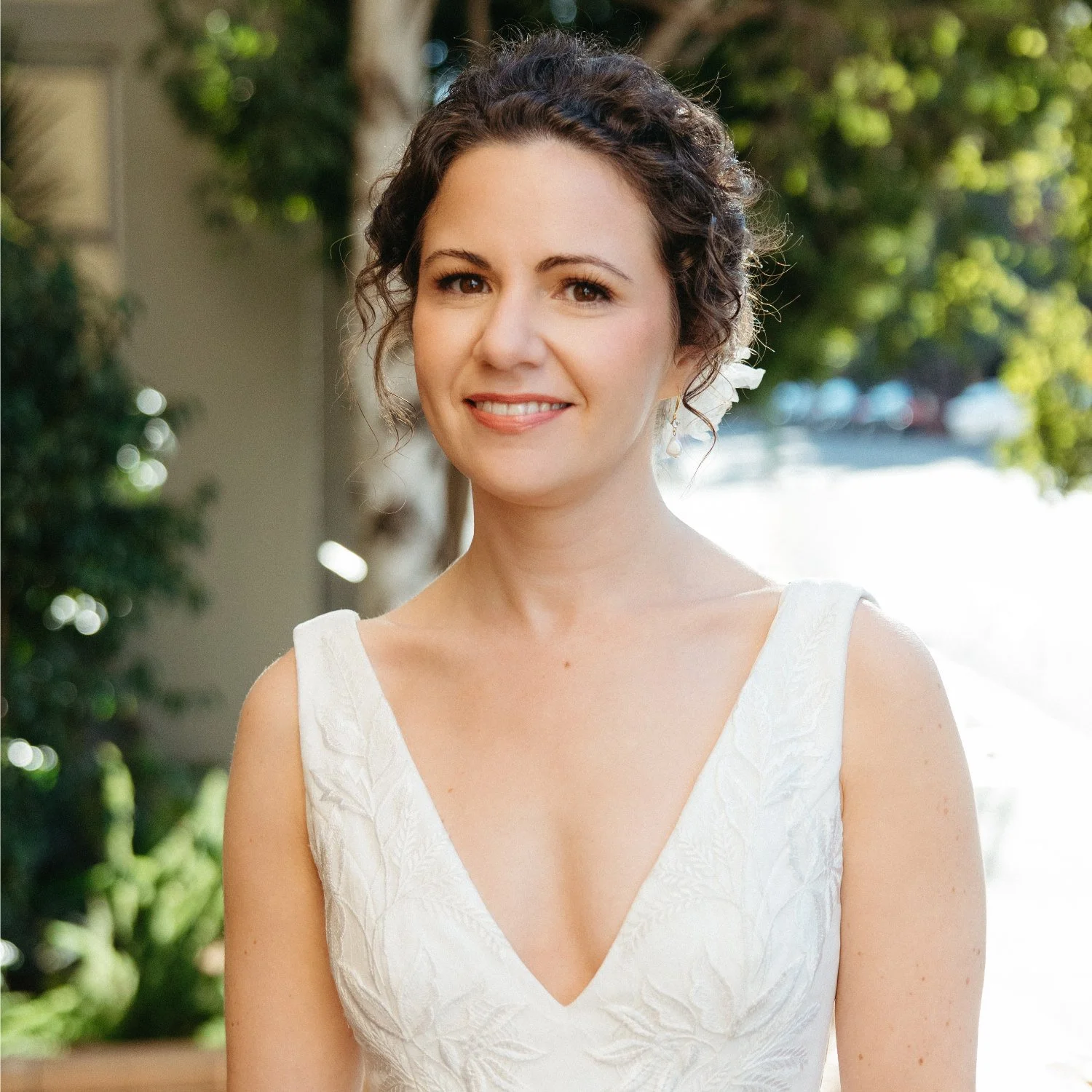 Curly hair in bridal updo with bridal makeup