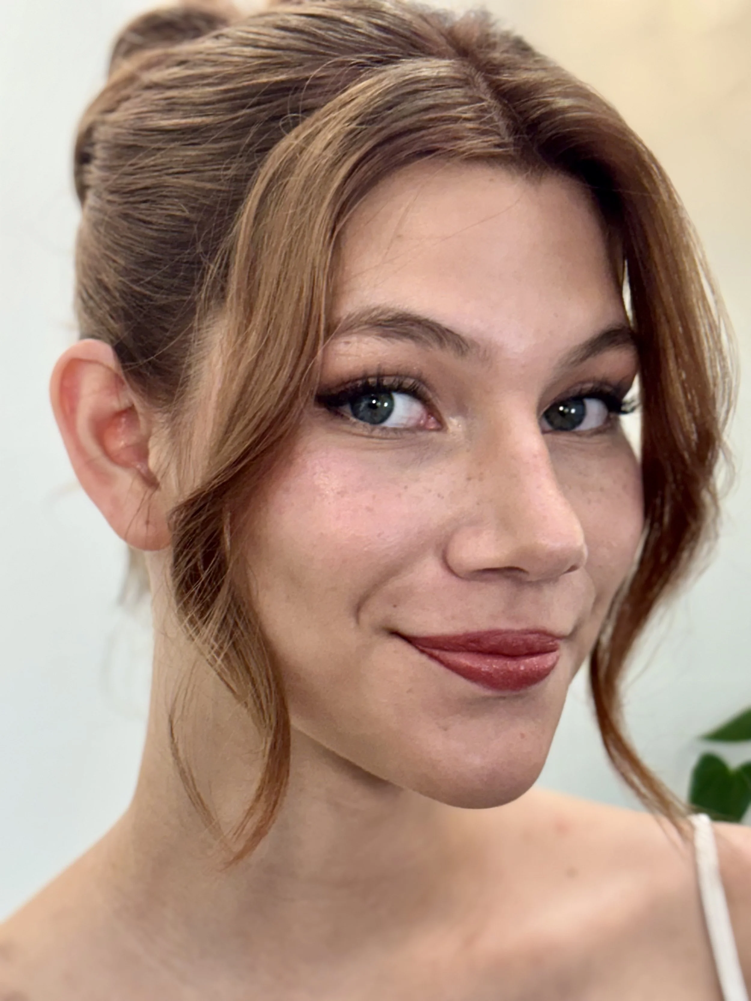 Model wearing soft glam bridal makeup with a natural, modern updo by ShineForth Beauty.