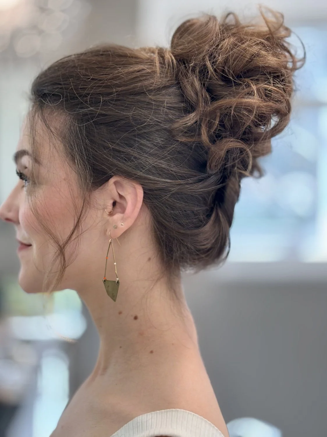 Soft, natural bridal hair and makeup detail close-up