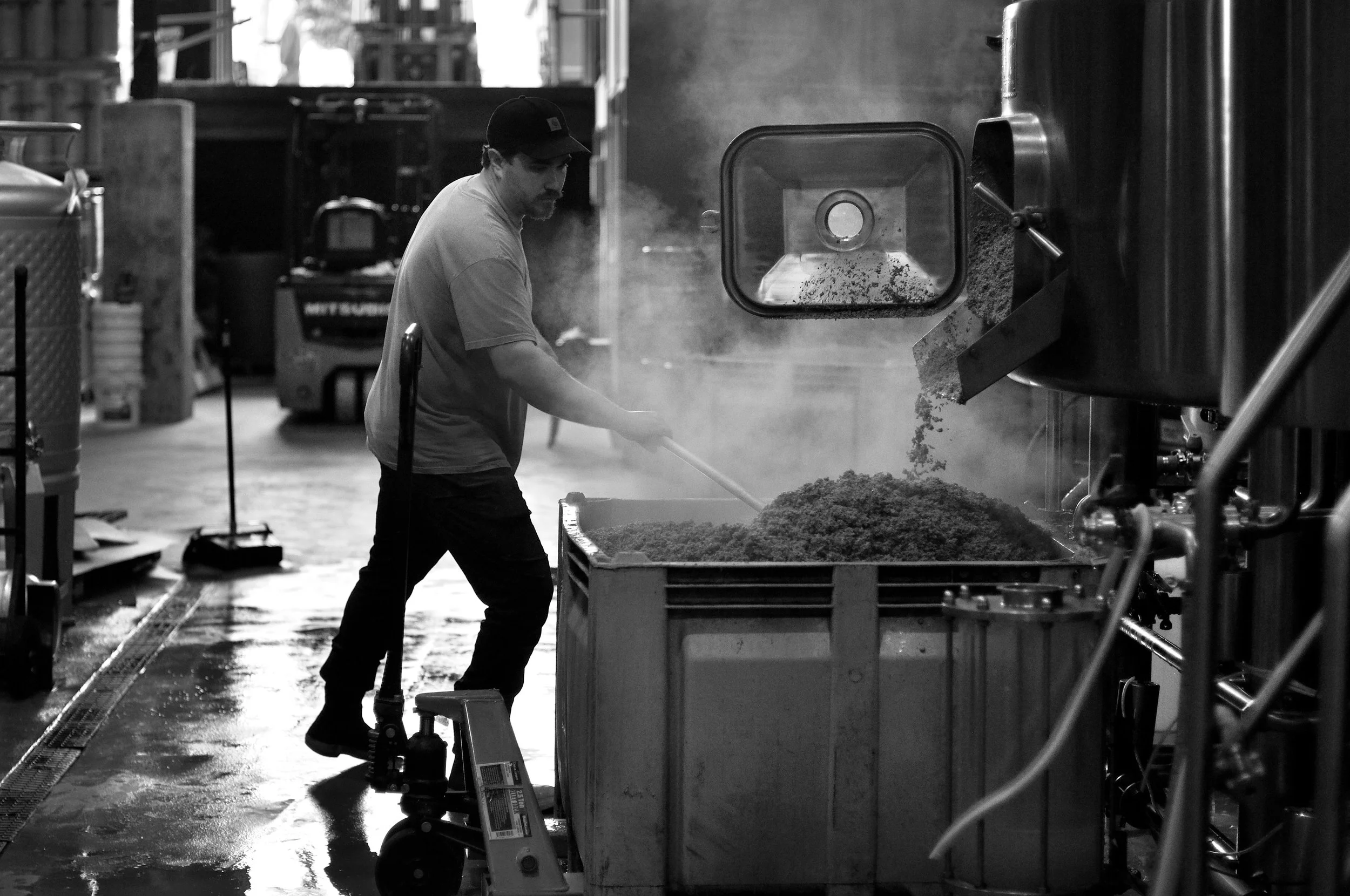 018.NICK CLEARS THE SPENT GRAINS FROM THE BREWING TANK.jpg