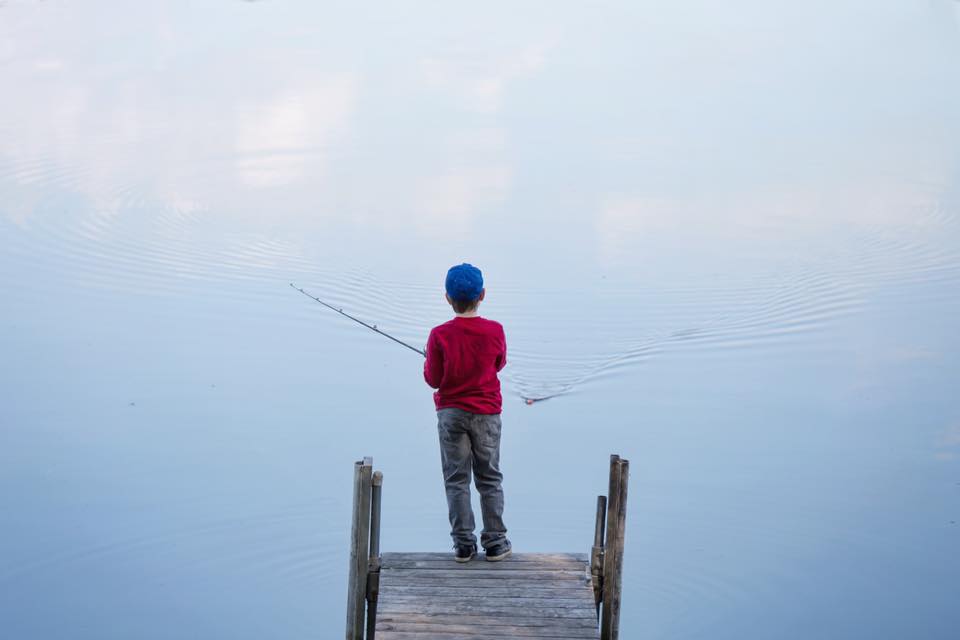 boy in blue cap fishing.jpg