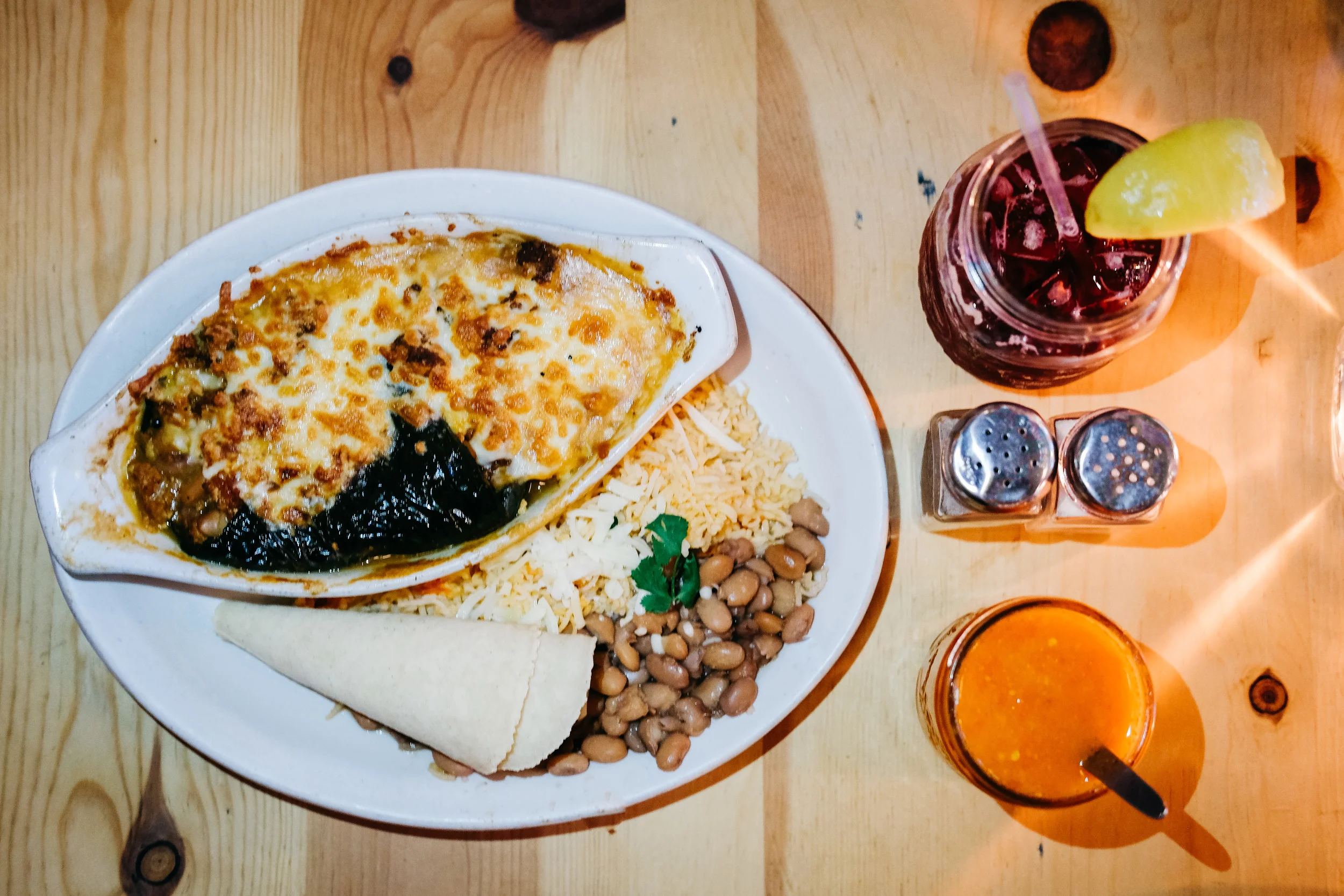 Sophie’s Poblano $12: A roasted poblano pepper stuffed with butternut squash and pinto beans. Baked in enchilada sauce and cheese. Served with two handmade corn tortillas and your choice of either beautiful side salad OR beans and rice.