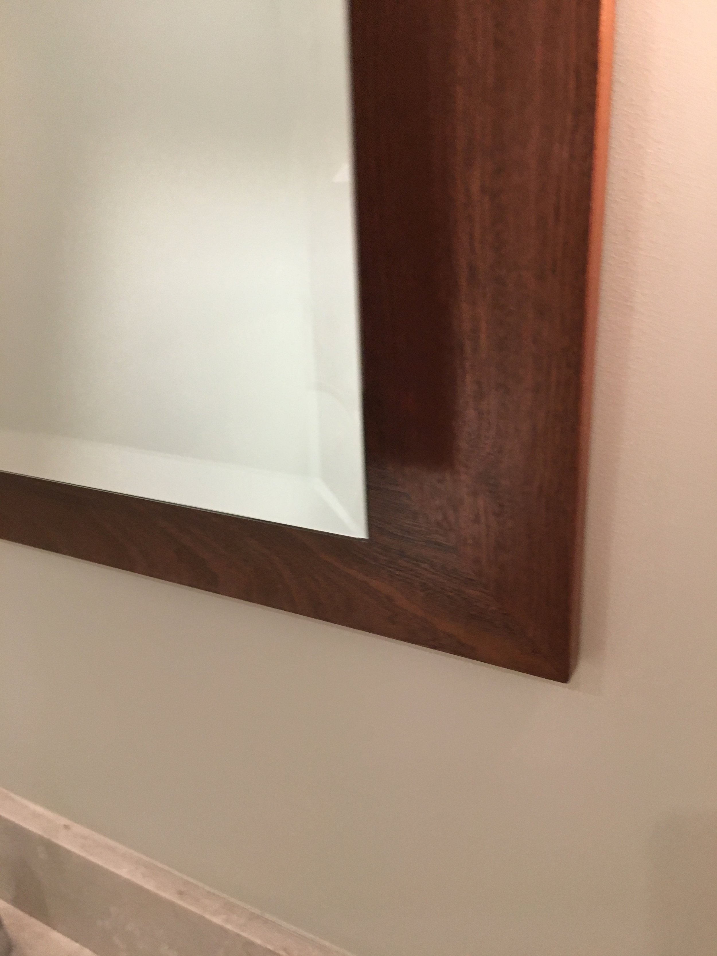 Custom floating mirror.  Mirror over mahogany.
