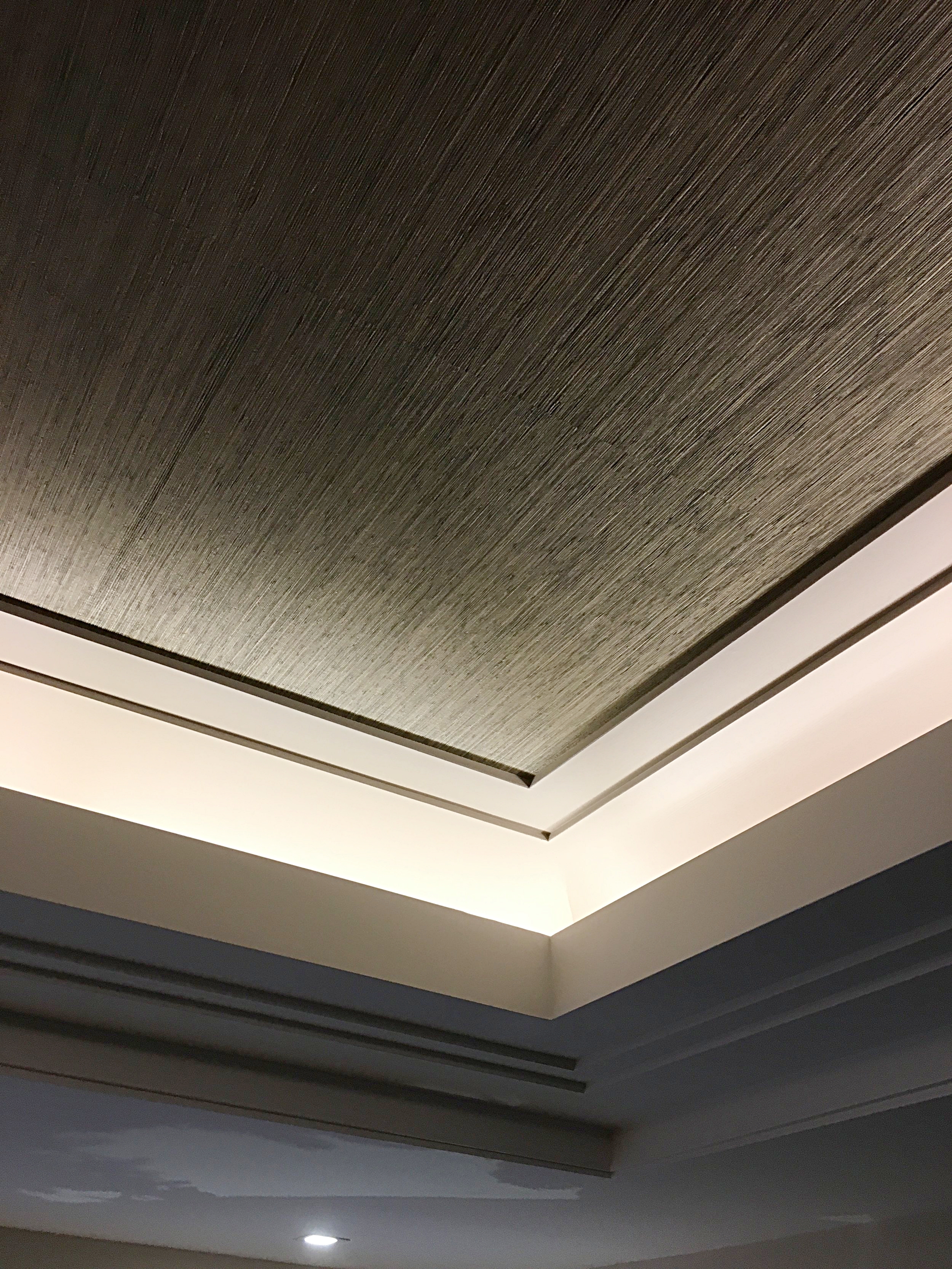 Custom tray ceiling with grass cloth as an accent.