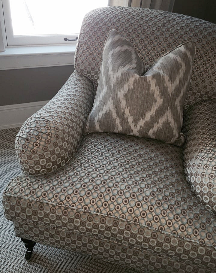 A reupholstered chair comes to life with contrasting patterns in different scales.