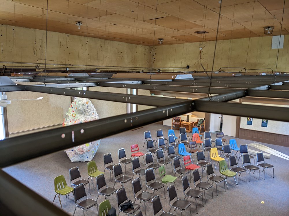  A view towards the future main exhibition space, set up for presentations, from above the drop ceiling grid likely added when the building became a library in the 80s. 