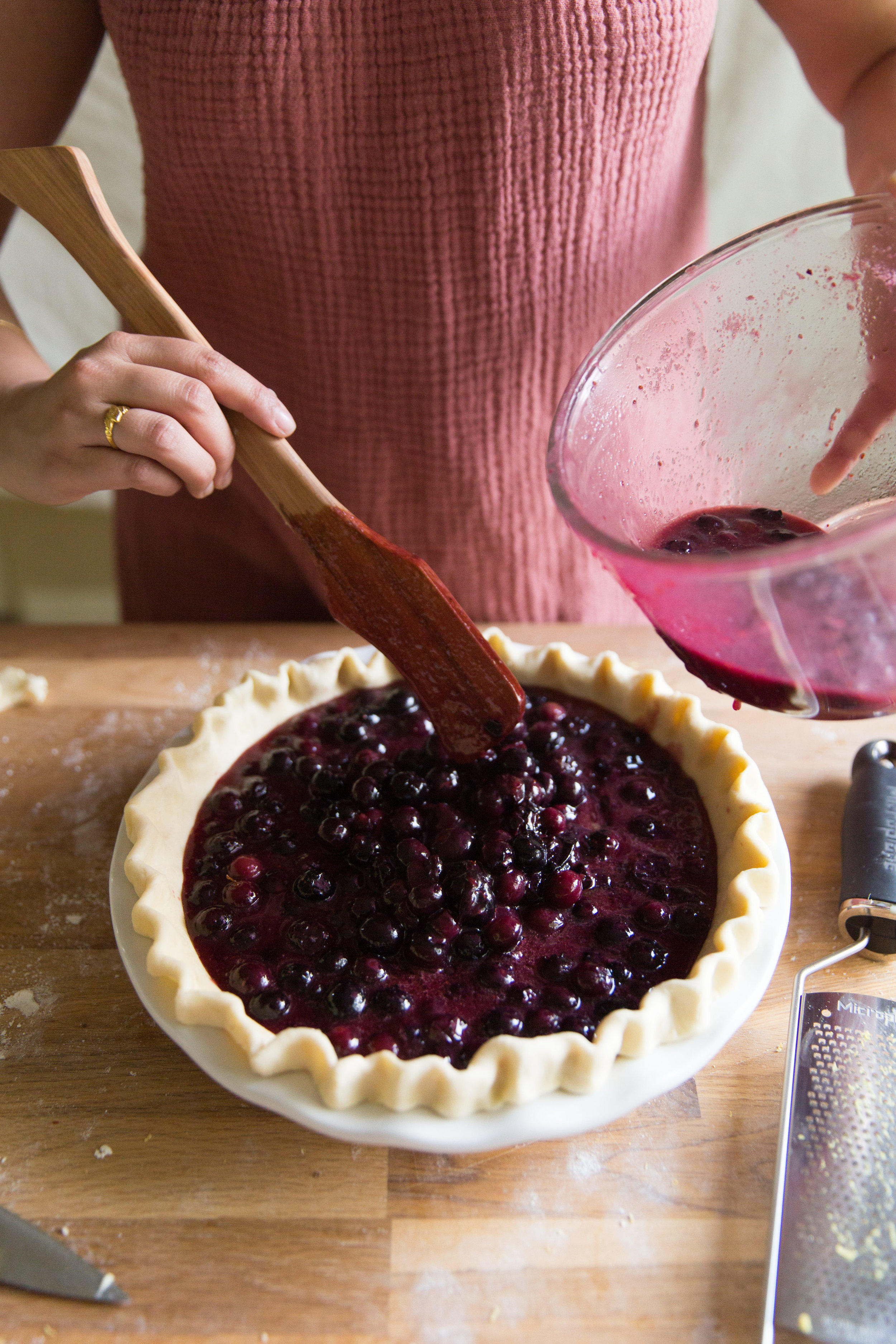 Pouring Blueberry Filling Into Pie Crust