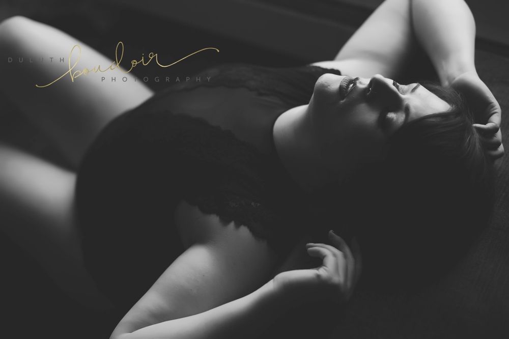 Angie wearing black lingerie with red lips for her boudoir photography session in Duluth, MN