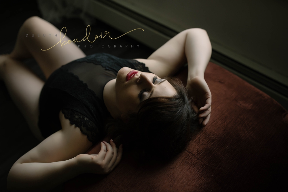Angie wearing black lingerie with red lips for her boudoir photography session in Duluth, MN