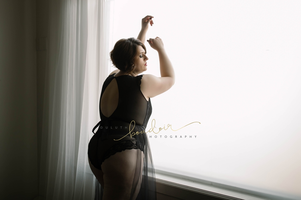 Angie wearing black lingerie with red lips for her boudoir photography session in Duluth, MN
