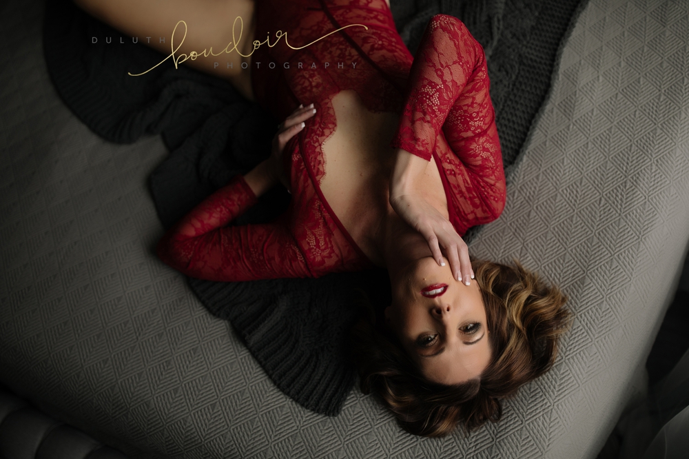 red bodysuit from Victoria's Secret | Jen at Duluth Boudoir Photography in Minnesota | boudoir photography on a bed