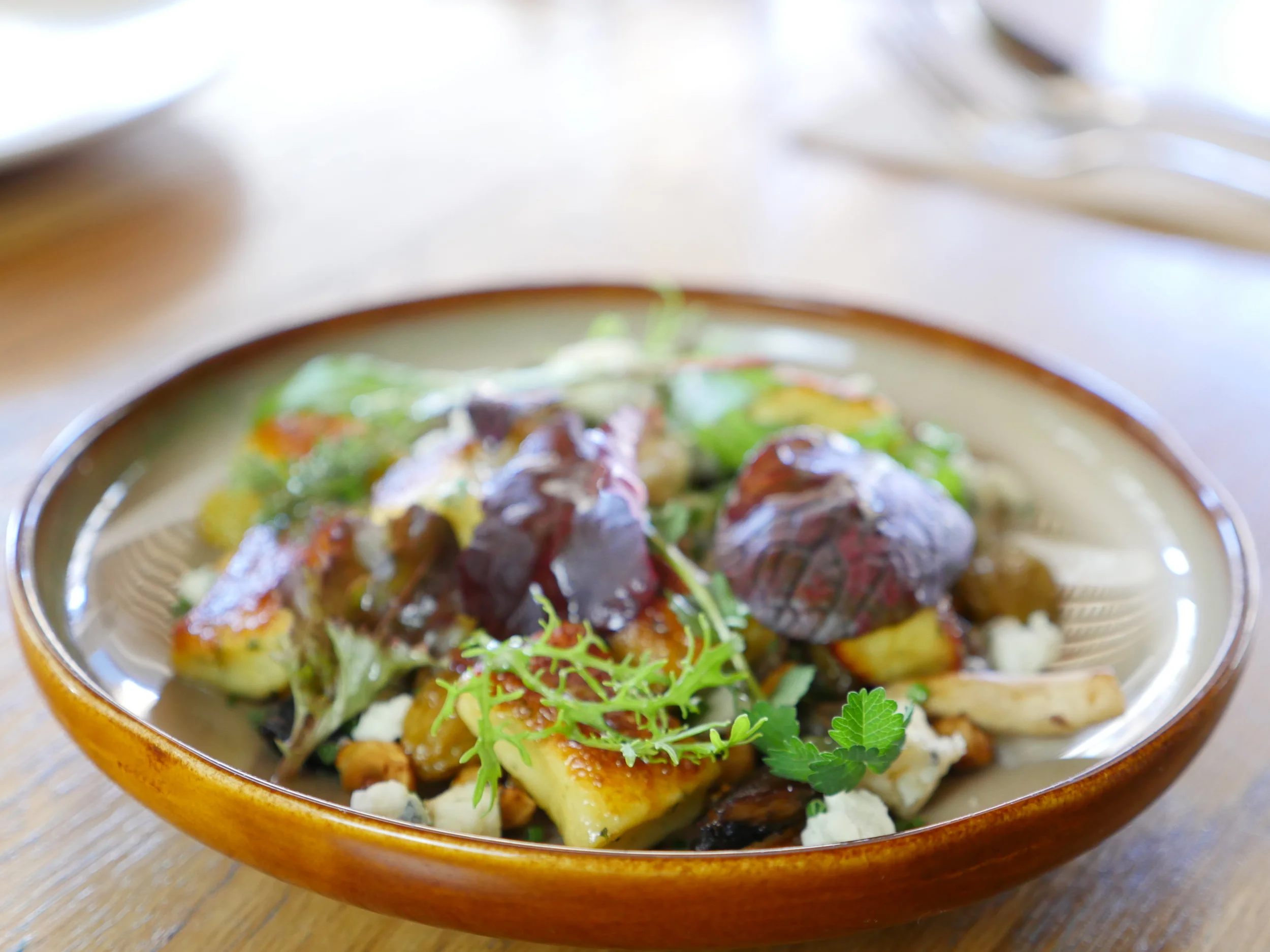 THYME GNOCCHI, GOLDEN RAISINS, HAZELNUTS, MUSHROOMS, GIPPSLAND BLUE, PETITE BOUCHE SEASONAL SALAD.