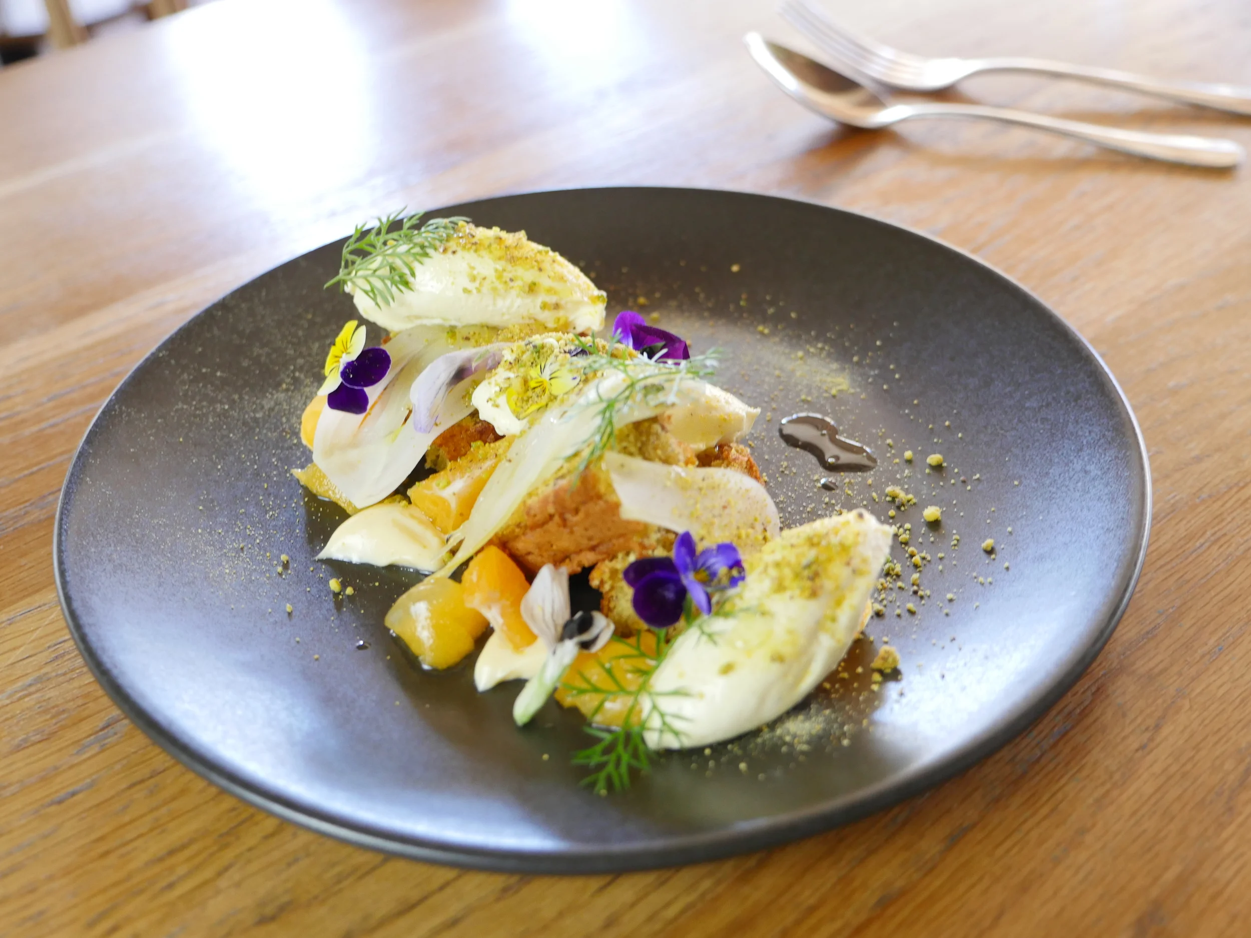 PISTACHIO, OILIVE OIL CAKE, FENNEL, MANDARIN, VANILLA CREME, BRONZE FENNEL, EDIBLE FLOWERS.