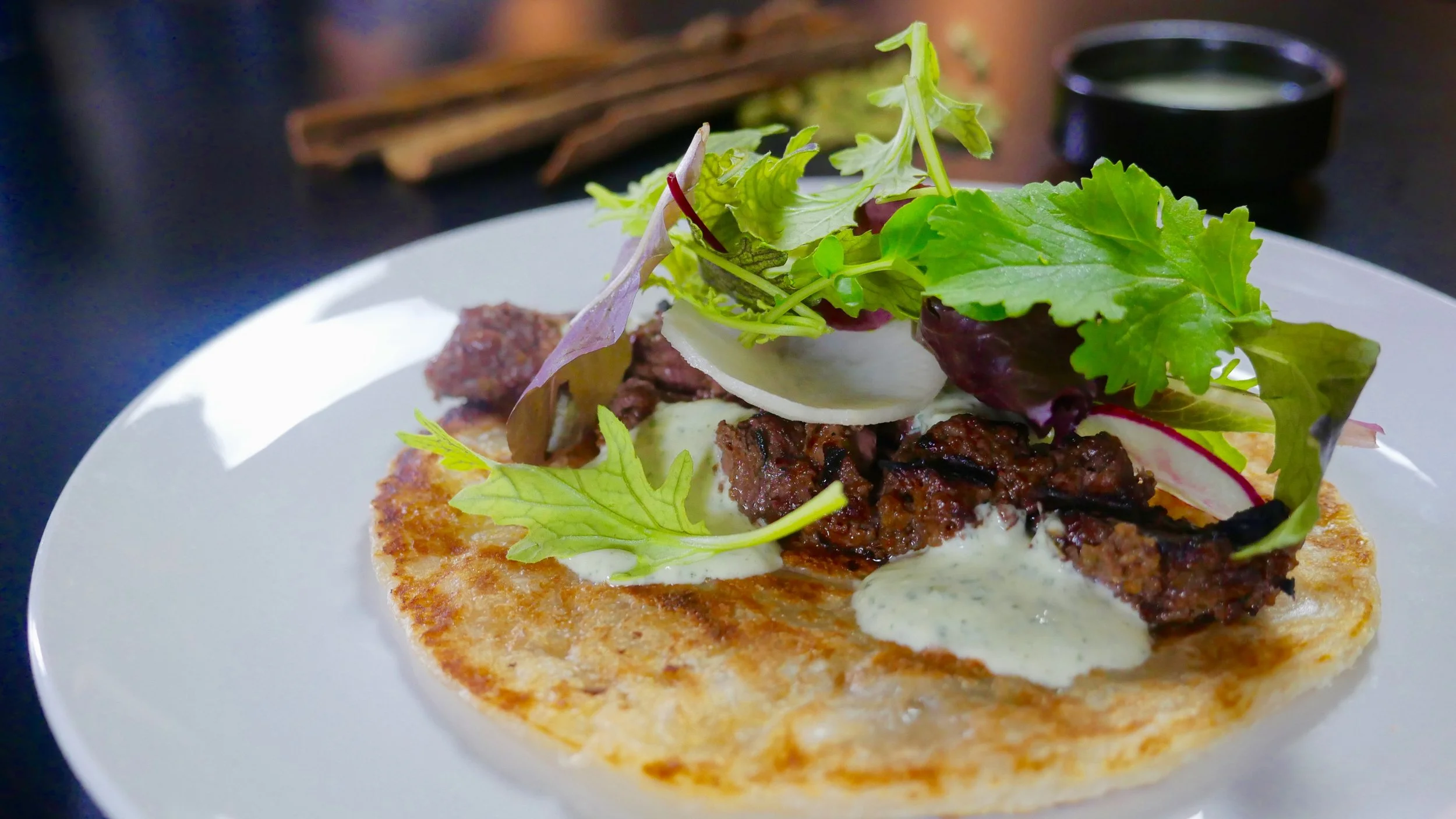 BANG BOTI KEBAB, HANGER STEAK, PARATHI ROTI, RADISH AND HOT MUSTARD MIX.