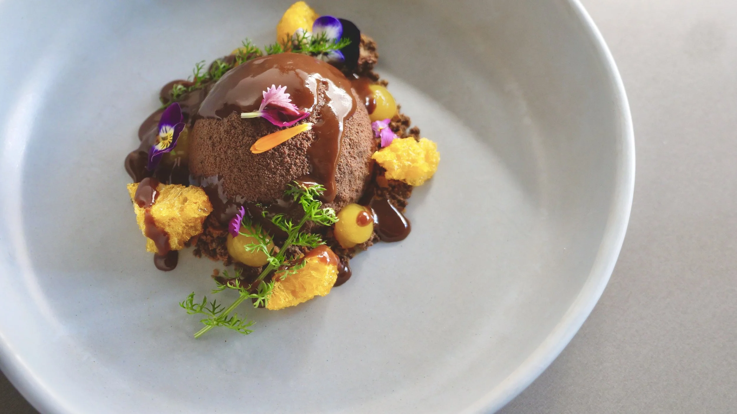 DARK CHOCOLATE MARQUISE, DULCEY MOUSSE, MANDARIN, DARK CHOCOLATE SAUCE, YARROW AND PETITE FLOWERS.