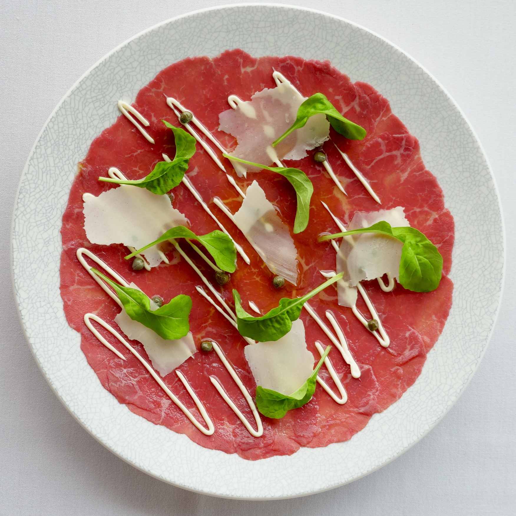 RIVERINA ANGUS BEEF, TRUFFLE DRESSING, AIOLI, CAPERS, PARMESAN, PETITE BOUCHE ROCKET.