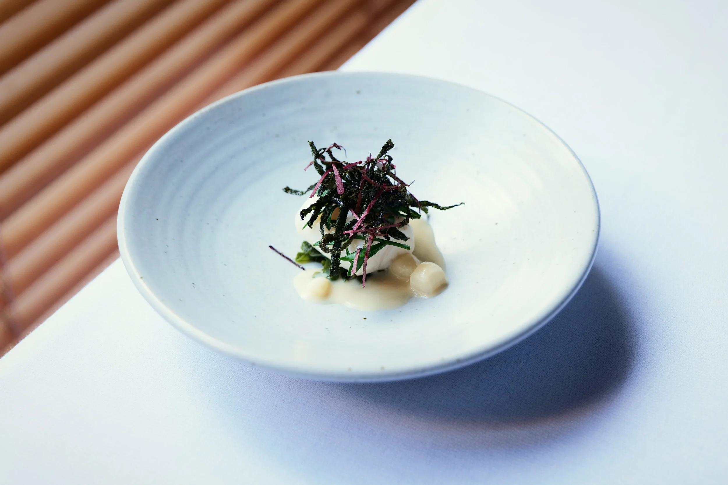 BASS GROUPER. LEMON MYRTAL, CREAM, CRISPY WAKAME, CRANBERRY HISBISCUS