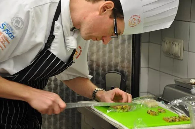 Core Member Scott Baechler slicing cold show terrine.