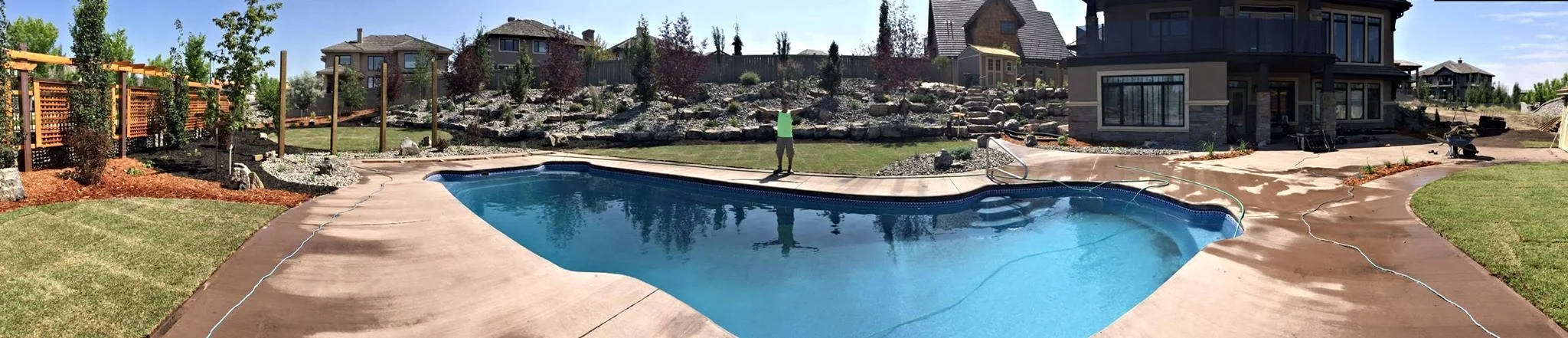 Tiered Boulder Retaining Walls in Edmonton backyard pool yard
