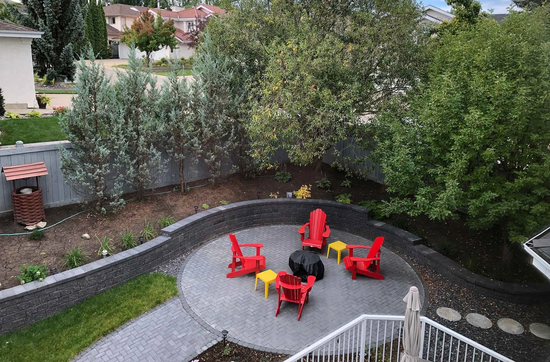 birds eye view of backyard retaining wall and seating patio area in riverbend edmonton