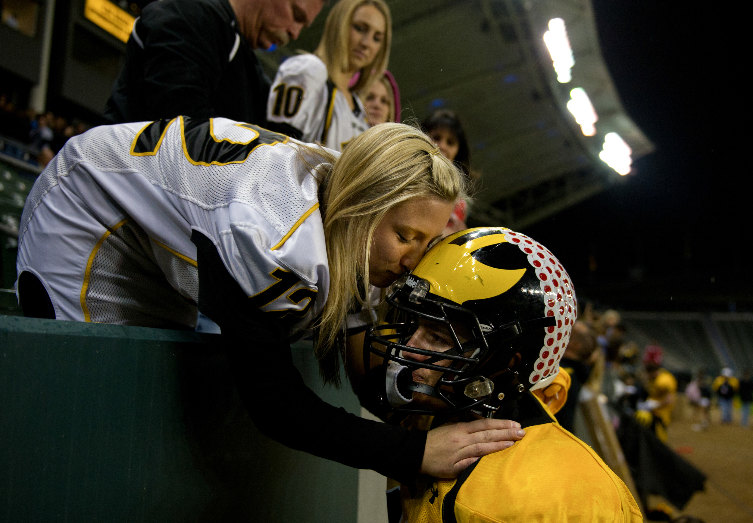  Del Oro quarterback Bobby Heatherington is embraced and kissed by his sister Lisa Heatherington following the 35-24 loss to Helix High School in Saturday afternoons CIF Div ll State Championship football game at the Home Depot Stadium in Carson, Cal