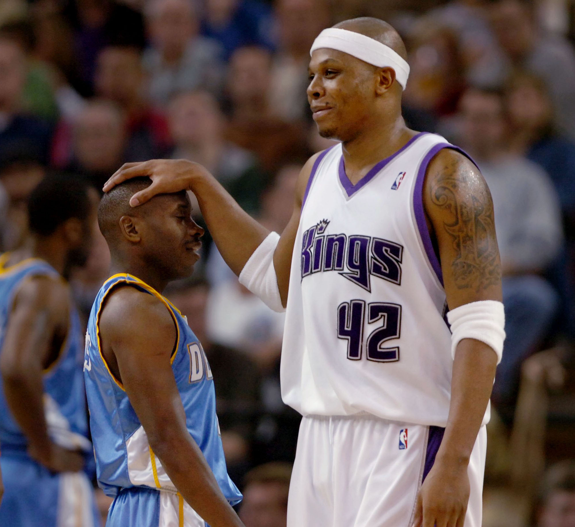 6' 5" Sacramento King Bonzi Wells responds in fun to the scrappy play of Denver Nuggets 5' 5" Earl Boykins after Boykins was whistled for a foul in the 2nd half of the game. 