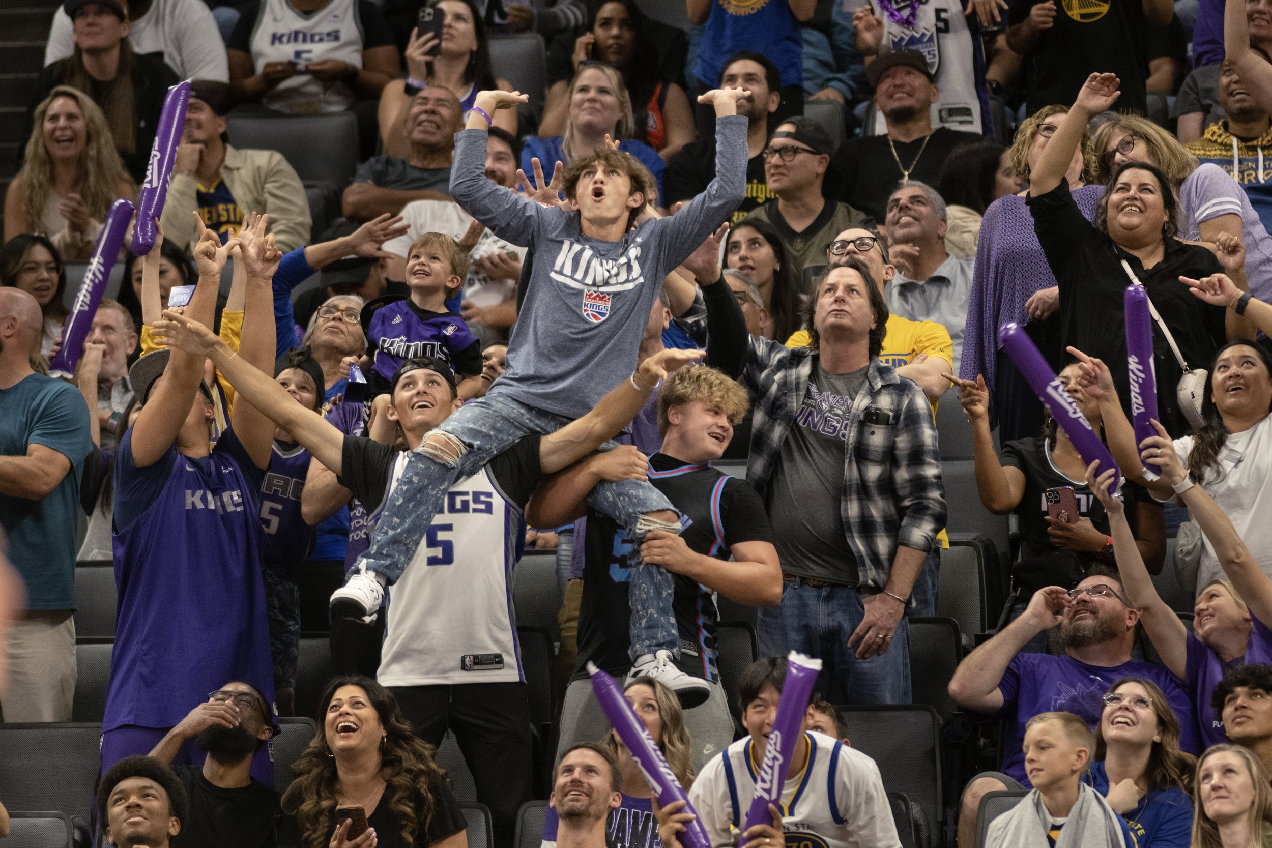  Sacramento Kings fans celebrate during a timeout in the second half in an NBA preseason basketball game between the Sacramento Kings and the Golden State Warriors  in Sacramento, California. 