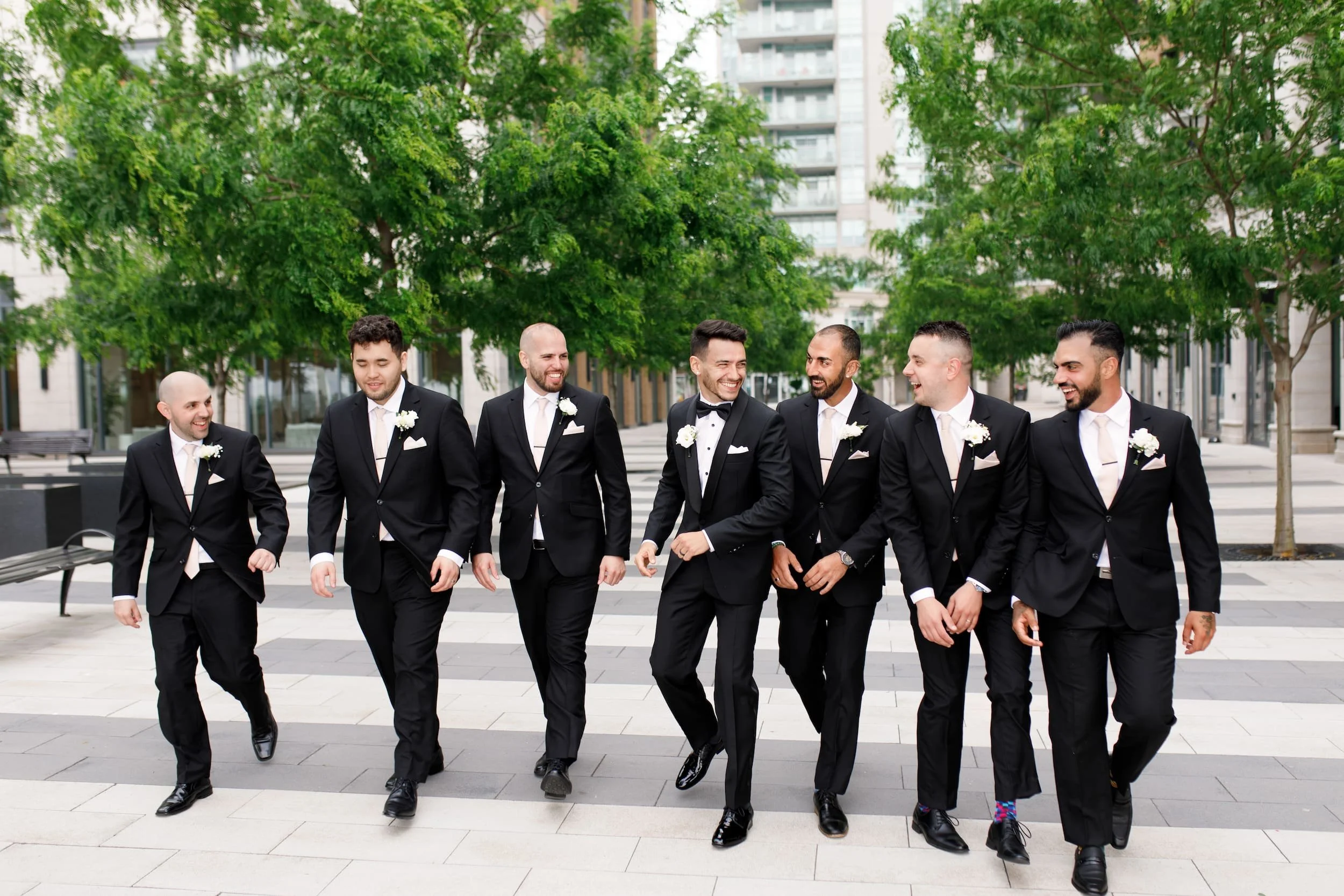 Groomsmen walking through downtown Burlington near The Pearle Hotel & Spa